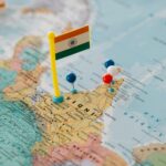 Indian map close-up with a flag and multiple colored pushpins.